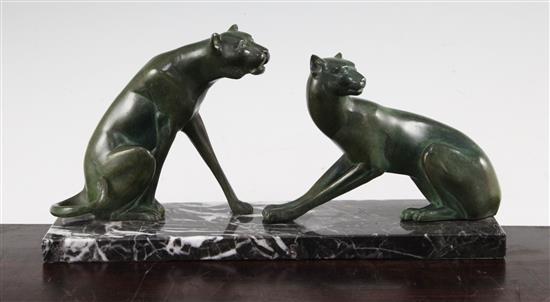 A French Art Deco green patinated metal model of two panthers, 12in.